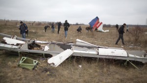 Journalists look at parts of the Malaysia Airlines plane Flight MH17 as Dutch investigators (unseen) arrive at the crash site near the Grabove village in eastern Ukraine on November 11, 2014, hoping to recover debris from the Malaysia Airlines plane which crashed in July, killing 298 people, in remote rebel-held territory east of Donetsk. The Dutch team hopes to begin work as soon as possible amid fears all-out fighting could break out again. AFP PHOTO / MENAHEM KAHANA (Photo credit should read MENAHEM KAHANA/AFP/Getty Images)